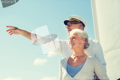 Image of happy senior couple on sail boat or yacht in sea