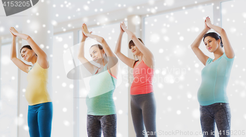 Image of happy pregnant women exercising in gym