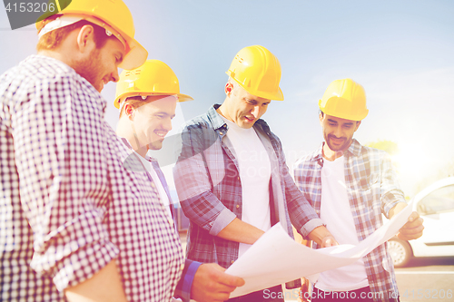 Image of group of builders with tablet pc and blueprint