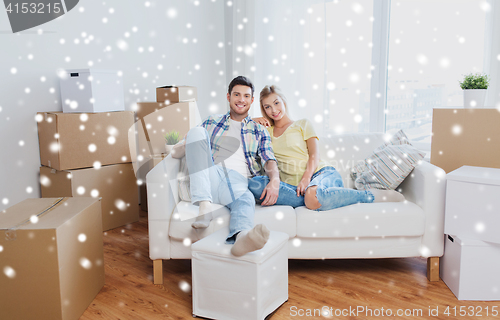 Image of happy couple with big cardboard boxes at new home