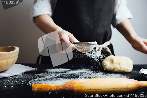 Image of Cook covering table with flour