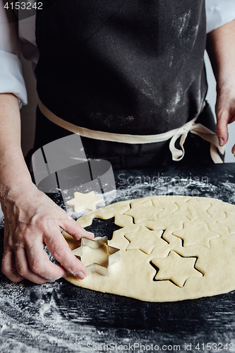 Image of Person forming star-shaped cookies