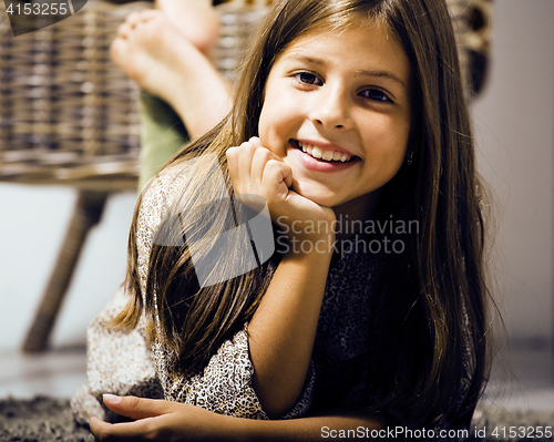 Image of little cute brunette girl at home interior happy smiling close u