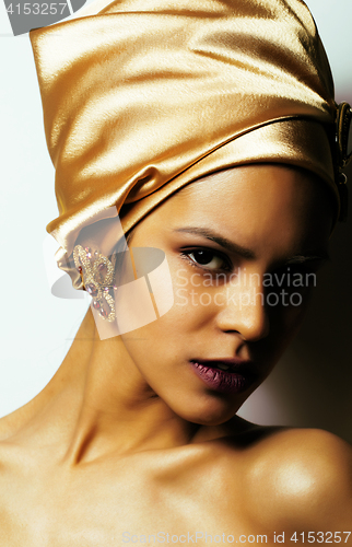 Image of beauty african woman in shawl on head, very elegant look with gold jewelry close up mulatto dark afro