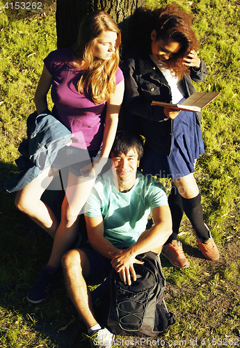 Image of cute group of teenages at the building of university with books 