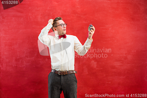 Image of Young funny man with abstract clock