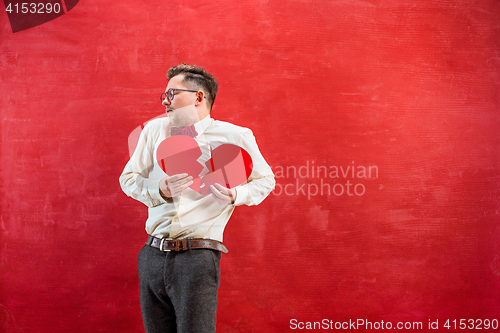Image of Young funny man with abstract broken heart and clock