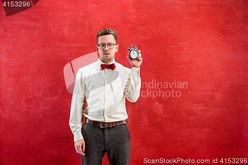 Image of Young funny man with abstract clock