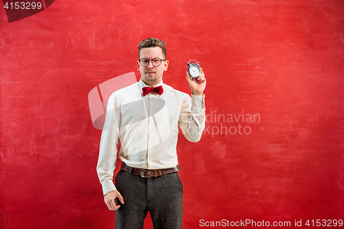 Image of Young funny man with abstract clock