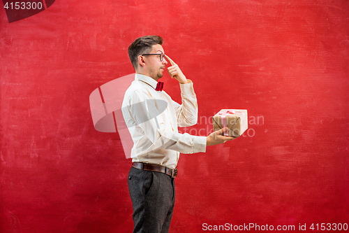 Image of Young funny man with gift