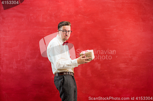 Image of Young funny man with gift