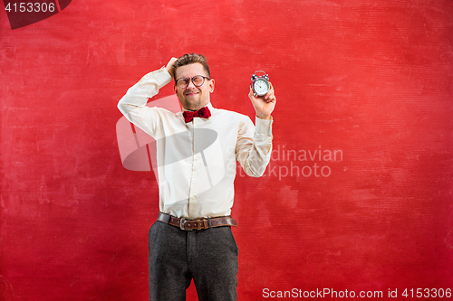 Image of Young funny man with abstract clock