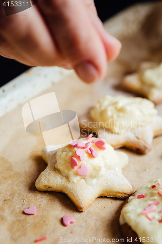 Image of Person decorating cookies