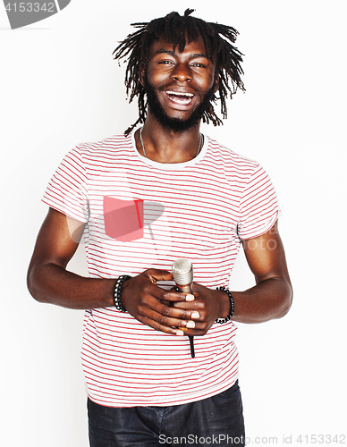 Image of young handsome african american boy singing emotional with microphone isolated on white background, in motion gesturing smiling, lifestyle people concept