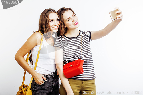 Image of two best friends teenage girls together having fun, posing emotional on white background, besties happy smiling, making selfie, lifestyle people concept