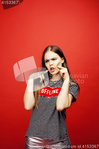 Image of young pretty emitonal posing teenage girl on bright red background, happy smiling lifestyle people concept