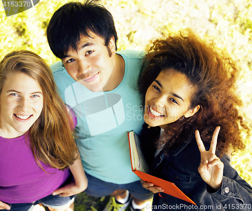 Image of cute group of teenages at the building of university with books 