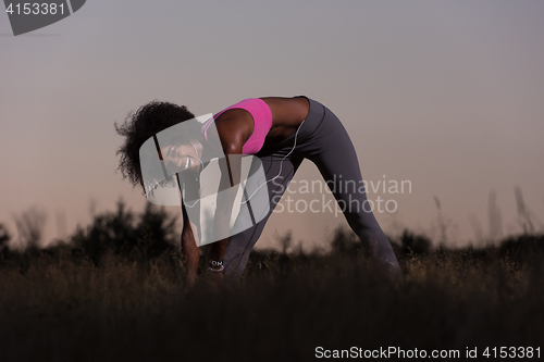 Image of black woman is doing stretching exercise relaxing and warm up