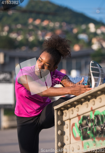 Image of African American woman doing warming up and stretching