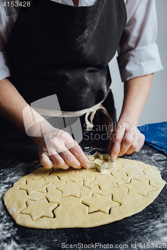 Image of Cook cut out dough for cookies