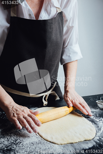 Image of Person rolling homemade cookie dough