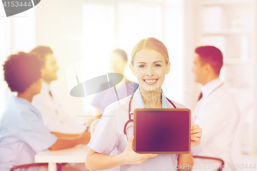 Image of happy doctor over group of medics at hospital