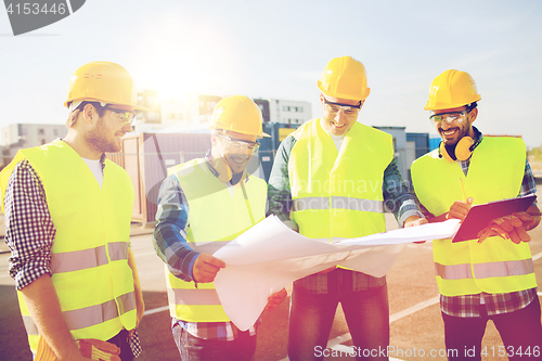 Image of group of builders with tablet pc and blueprint