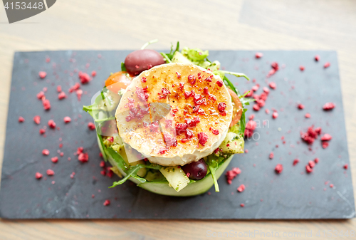 Image of goat cheese salad with vegetables at restaurant