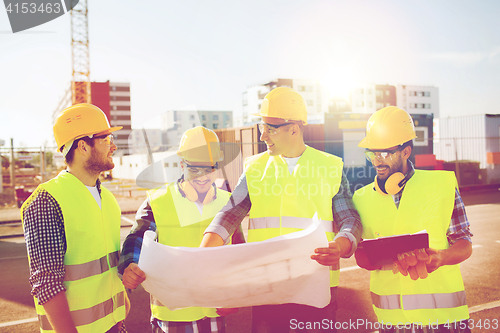 Image of group of builders with tablet pc and blueprint