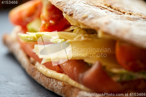 Image of close up of panini sandwich with salmon and cheese