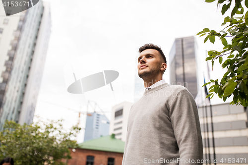 Image of young man on city street