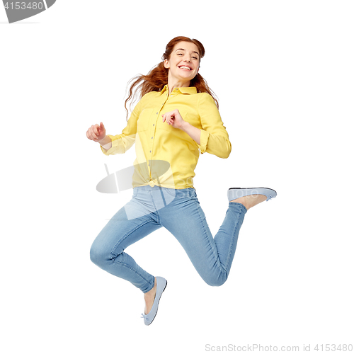 Image of smiling young woman jumping in air