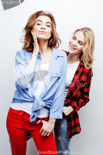 Image of two pretty blond woman having fun together on white background, mature mother and young teenage daughter, lifestyle people concept