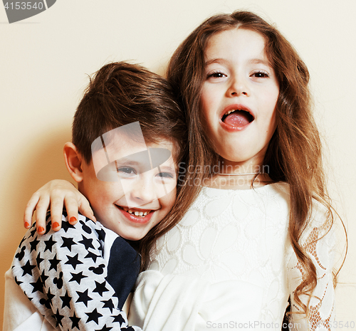 Image of little cute boy and girl hugging playing on white background, ha