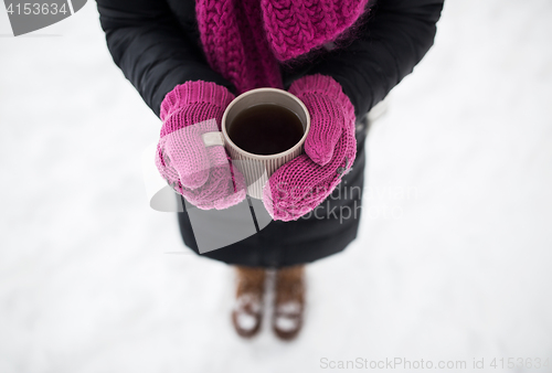 Image of close up of woman with tea mug outdoors in winter