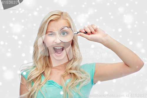 Image of happy young woman with magnifying glass