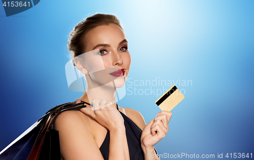 Image of woman with credit card and shopping bags