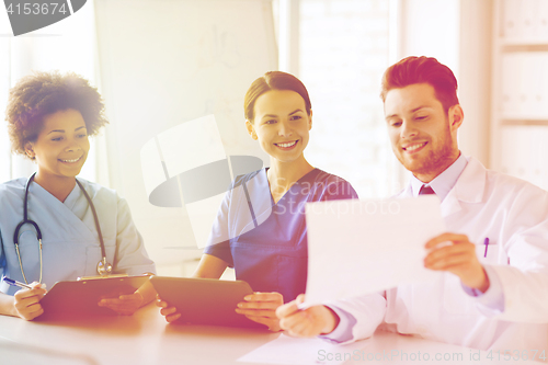 Image of group of happy doctors meeting at hospital office