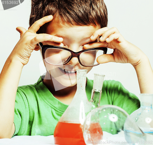 Image of little cute boy with medicine glass isolated wearing glasses smi