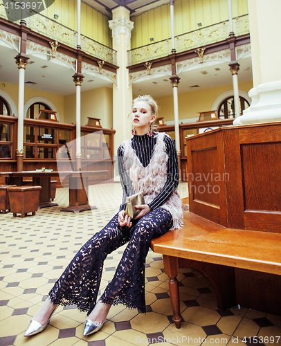 Image of young attractive fashion lady on railway station waiting, vintage people concept in classic interior
