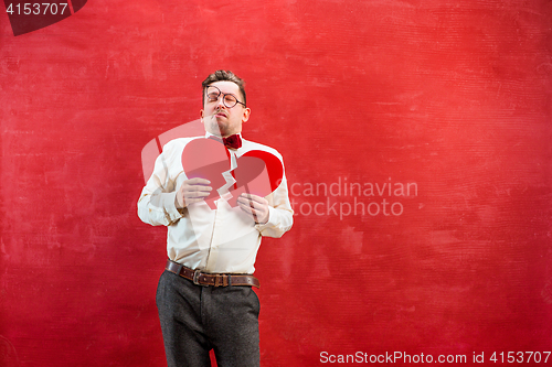 Image of Young funny man with abstract broken heart