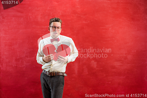 Image of Young funny man with abstract broken heart and clock