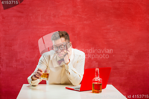 Image of Young funny man with laptop at St. Valentine\'s Day