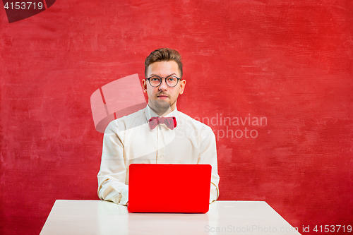 Image of Young funny man with laptop at St. Valentine\'s Day