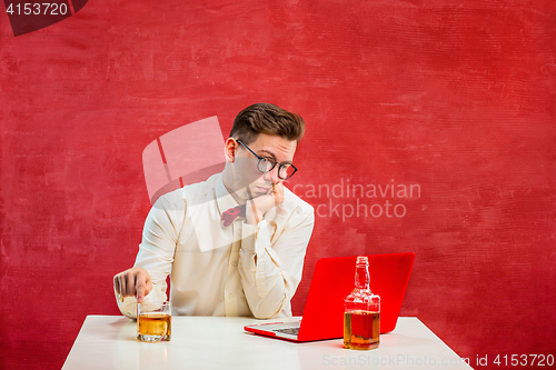 Image of Young funny man with laptop at St. Valentine\'s Day
