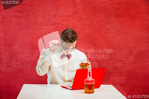 Image of Young funny man with laptop at St. Valentine\'s Day