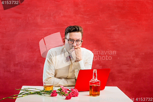 Image of Young funny man with flowers