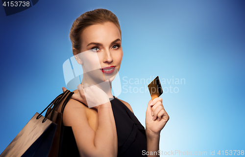 Image of woman with credit card and shopping bags