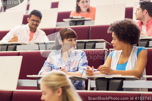 Image of group of students talking in lecture hall