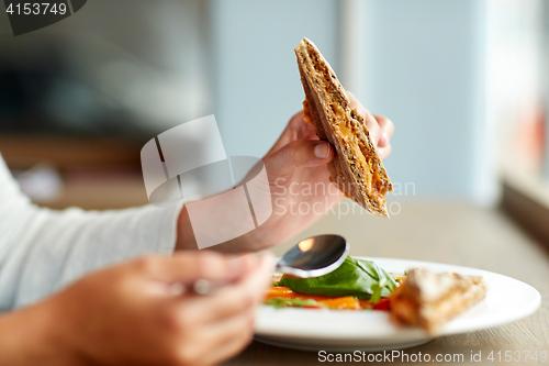 Image of woman eating gazpacho soup at restaurant